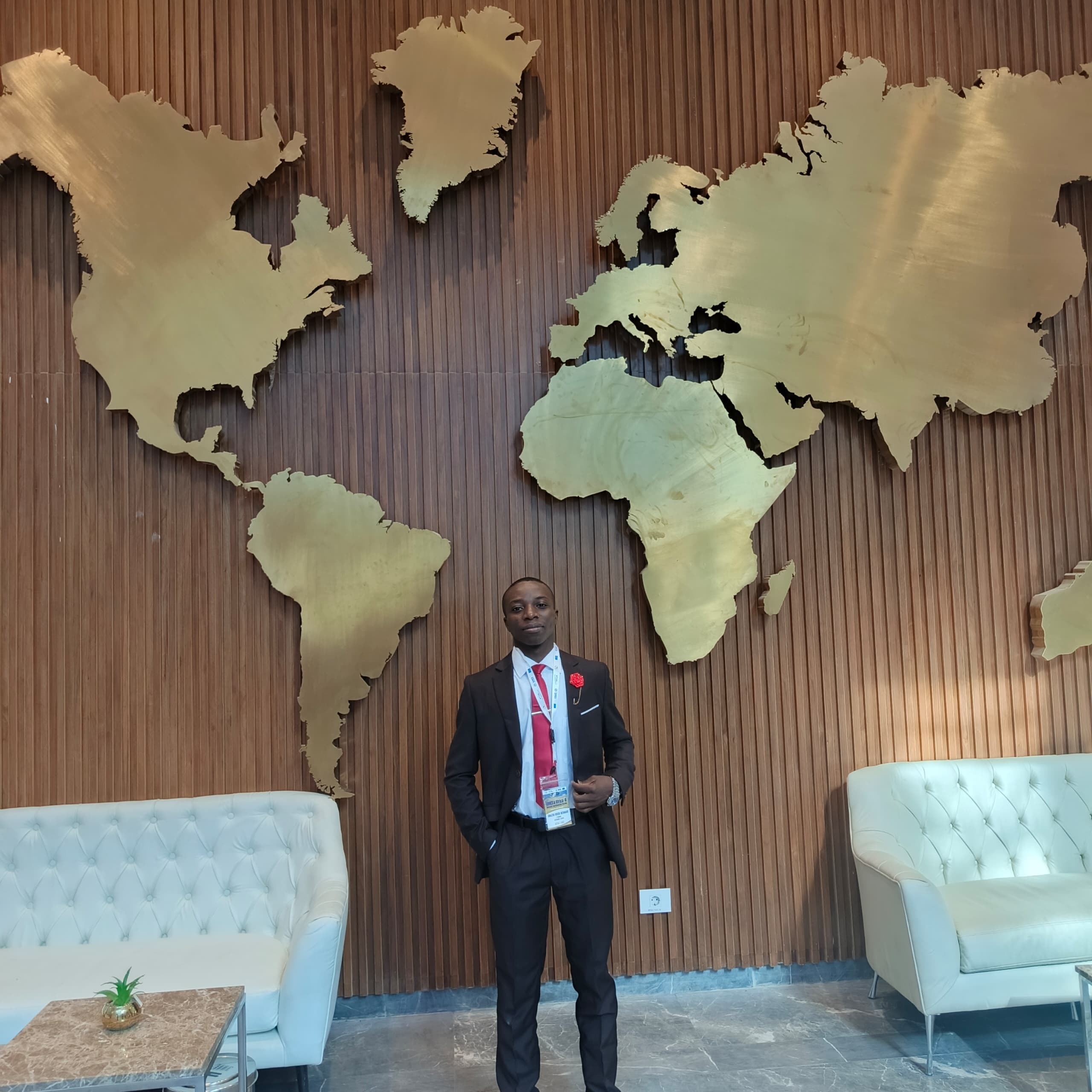 Bernard Gnazou in front of the golden world map at AfSA headquarters